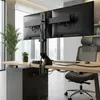 A modern office desk setup with a dual monitor mount, computer, and chair. Podgląd zdjęcia produktu