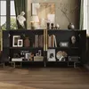 A black sideboard with gold accents, filled with decorative items and books, set in a room with a window and artwork. Podgląd zdjęcia produktu