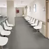 A waiting area in a clinic or hospital with rows of white chairs. Podgląd zdjęcia produktu