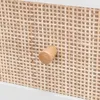 Close-up of a drawer knob on a rattan-woven surface. Produktbild-Vorschau