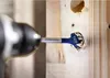 A drill bit is drilling a hole in a wooden surface. Produktbild-Vorschau