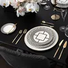 A formal table setting with orchids and gold-accented dinnerware. Náhled obrázku produktu