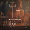 A couple is dining at a table, with a diagram of a table lamp overlaid on the image. Anteprima dell’immagine prodotto