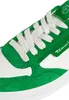 A close-up view of the front of a green and white sneaker. Produktbild-Vorschau