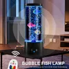 A bubble fish lamp with artificial fish and blue bubbles is displayed on a black table in a dimly lit room. Produktbild-Vorschau