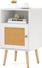 A white wooden nightstand with a cane door and wooden legs, placed on a white background. Podgląd zdjęcia produktu