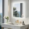 A modern bathroom vanity with a marble countertop, sink, and a lit mirror reflecting a scenic view. Podgląd zdjęcia produktu