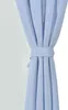 A close-up of a light blue curtain tied with a matching fabric tie. Produktbild-Vorschau