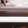 A close-up view of a mirror with illuminated buttons and a blurred background of a couch and pillows. Náhled obrázku produktu