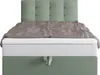 A boxspring bed with a headboard and bedding. Produktbild-Vorschau