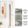 A tall, beige cat scratching post hanging from a hook on a wall, with a cat climbing it in a smaller inset image. Dimensions and feature callouts are shown. Produktbild-Vorschau