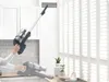 A person is using a cordless vacuum cleaner to clean near an air vent and window blinds. Náhled obrázku produktu