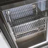 A close-up view of the interior of an outdoor kitchen unit, showing stainless steel racks and the interior of a refrigerator or cabinet. Anteprima dell’immagine prodotto