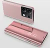 A pink smartphone with a clear view flip case is shown, with a second phone in the background. Produktbild-Vorschau