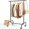 A black garment rack with clothes and a handbag hanging on it, placed on a white background. Produktbild-Vorschau