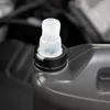 Close-up of the cap of a motor oil bottle, with the engine bay of a car in the blurred background. Produktbild-Vorschau