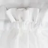 Close-up of the top edge of a white sheer curtain with gathered pleats and a rod pocket. Produktbild-Vorschau