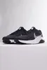 A pair of black Nike Legend Essential 3 Nn men's shoes with white soles and silver accents is displayed against a light gray and white background. Náhľad obrázku produktu