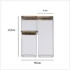 Two glass jars with wooden lids are shown side-by-side, with dimensions indicated. Anteprima dell’immagine prodotto