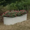 A raised garden bed filled with pink flowers in a garden setting. Produktbild-Vorschau