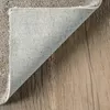 A close-up view of a rug corner, showing the texture of the material and the backing. Produktbild-Vorschau
