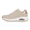 A side view of a single beige sneaker with gold accents. Produktbild-Vorschau