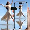 A person is holding a smartphone that displays a reflection of a dancer. A small black toggle switch is visible on the left side of the image. Voir les images du produit