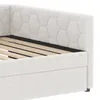 Close-up view of a white upholstered bed frame with a slatted wooden base. Podgląd zdjęcia produktu