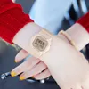 A person's wrist wearing a beige digital watch. Podgląd zdjęcia produktu