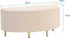 A beige upholstered storage bench with gold metal legs, shown with dimensions indicated by text overlays. Produktbild-Vorschau