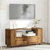 A wooden TV stand with a television mounted on the wall above it. Podgląd zdjęcia produktu