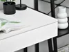 A close-up view of a white desk with a magazine on it, and part of a black shelving unit with a white vase. Anteprima dell’immagine prodotto