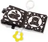 A black and white fabric book for babies, open to show pages with illustrations of a rabbit and a bear, with a yellow teether attached. Produktbild-Vorschau