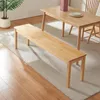 A wooden bench and dining table are placed on a rug in a room. Voir les images du produit