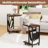 Two C-shaped side tables with storage bags are shown next to a sofa in a living room setting. Voir les images du produit