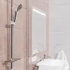 A modern bathroom with a shower head, sink, and mirror. Anteprima dell’immagine prodotto