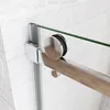 Close-up of a shower door sliding mechanism against a white brick-patterned wall. Produktbild-Vorschau