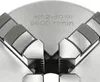 A close-up view of a four-jaw chuck for a lathe, showing the precision jaws and engraved specifications. Podgląd zdjęcia produktu