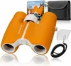 A product shot of children's binoculars and accessories, with packaging in the background. Náhľad obrázku produktu