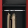 Inside view of a closet with clothes hanging on a rod. Voir les images du produit