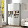 A white storage cabinet with shelves and doors, placed in a room with natural light from a window. Podgląd zdjęcia produktu
