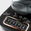 A close-up of a black and copper automatic tea maker with various function buttons and indicators illuminated. Produktbild-Vorschau