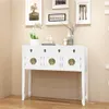 A white Chinese-style sideboard with gold hardware is displayed against a light beige wall, with framed artwork above it. Náhled obrázku produktu