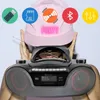 A person wearing a pink cap is holding a boombox in front of their face, with icons representing different features displayed above the cap. Voir les images du produit