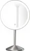 A silver LED stand cosmetic mirror with a round illuminated face and a circular base. Produktbild-Vorschau
