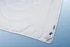 A white duvet is shown laid out on a light blue background. Produktbild-Vorschau