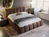 A bedroom scene featuring a bed with brown upholstery, white bedding, and a rug. Produktbild-Vorschau