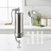 A stainless steel vertical sausage stuffer with a hand crank and four filling funnels sits on a marble countertop in a kitchen setting. Anteprima dell’immagine prodotto