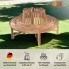 A wooden circular bench with a tree trunk enclosure, placed on a grassy lawn with a paved path in the background. Produktbild-Vorschau