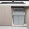 A gray trash can with a diamond-patterned lid is shown installed under a kitchen sink. Voir les images du produit